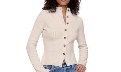 A woman wearing blue jeans and an off-white cardigan
