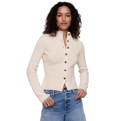 A woman wearing blue jeans and an off-white cardigan