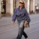 Steff Heubl is seen wearing a navy blue and white striped peplum blouse from Zara; two tone patchwork wide leg jeans from Zara; woven beige flat shoes from Zara; a vintage Gucci monogram canvas shoulder bag; Chloé oversized sunglasses; long blonde hair worn loose on September 15, 2026 in Munich, Germany.