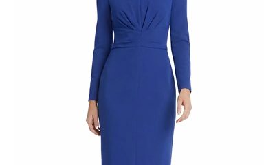 A woman wearing a bright blue sheath dress