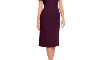 A woman wearing a plum-colored dress with black strappy heels