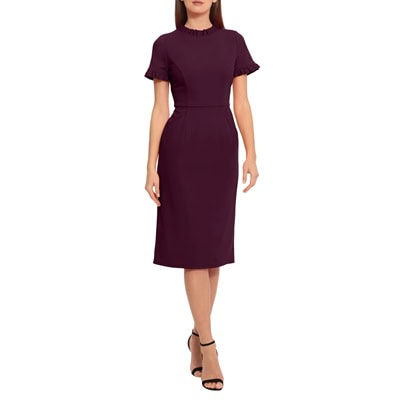 A woman wearing a plum-colored dress with black strappy heels