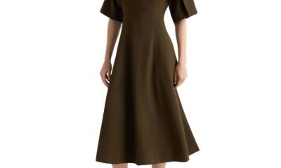 A woman wearing a brown midi dress and black flats