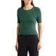 A woman wearing a green short-sleeved sweater and black pants