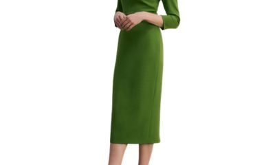 A woman wearing a green dress and black pumps