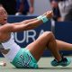 Qinwen Zheng falls to the ground in celebration after beating Madison Keys