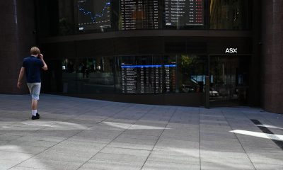 Aussie shares sink back into red as bond yields spike