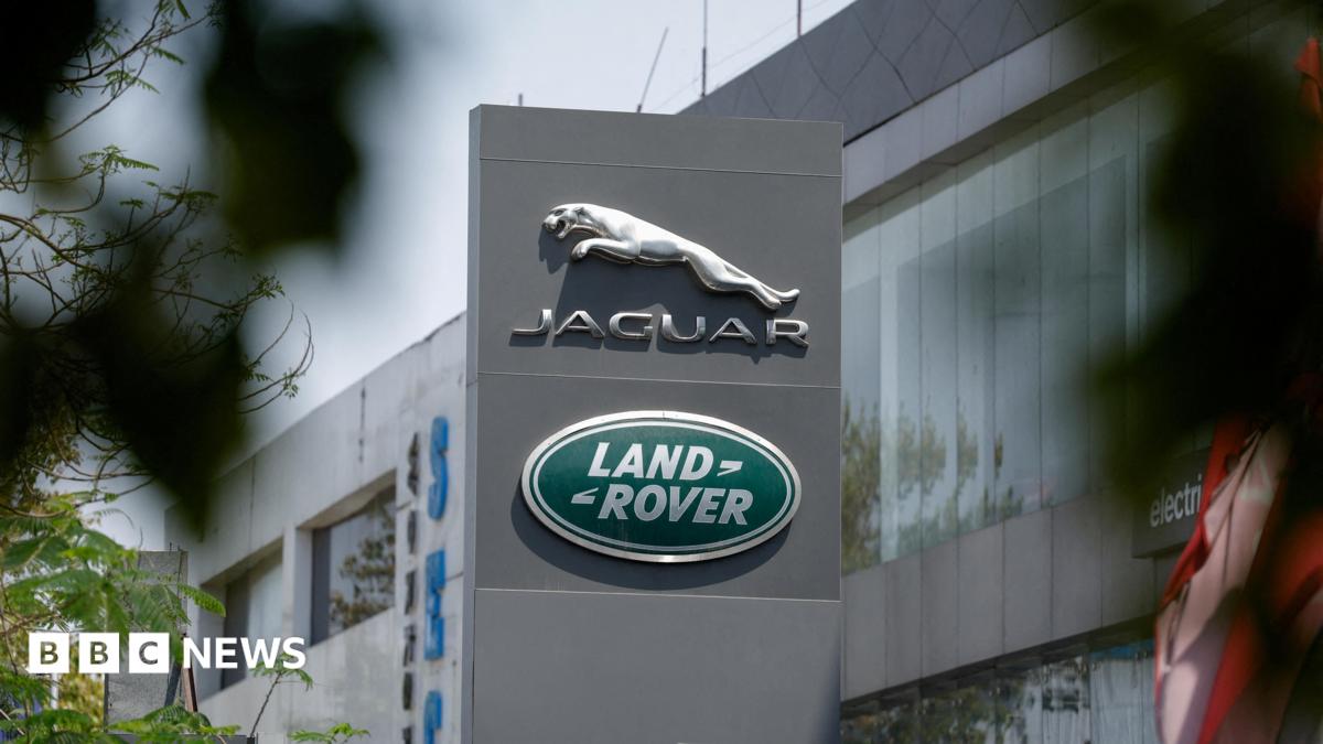 The silver leaping Jaguar emblem is on a grey pillar sign outside one of its factories with the green, oval Land Rover badge below.