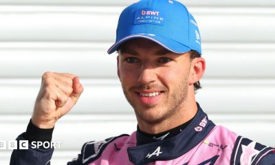 Alpine's Pierre Gasly poses with a picture of the '1' board after taking pole position at the Italian Grand Prix