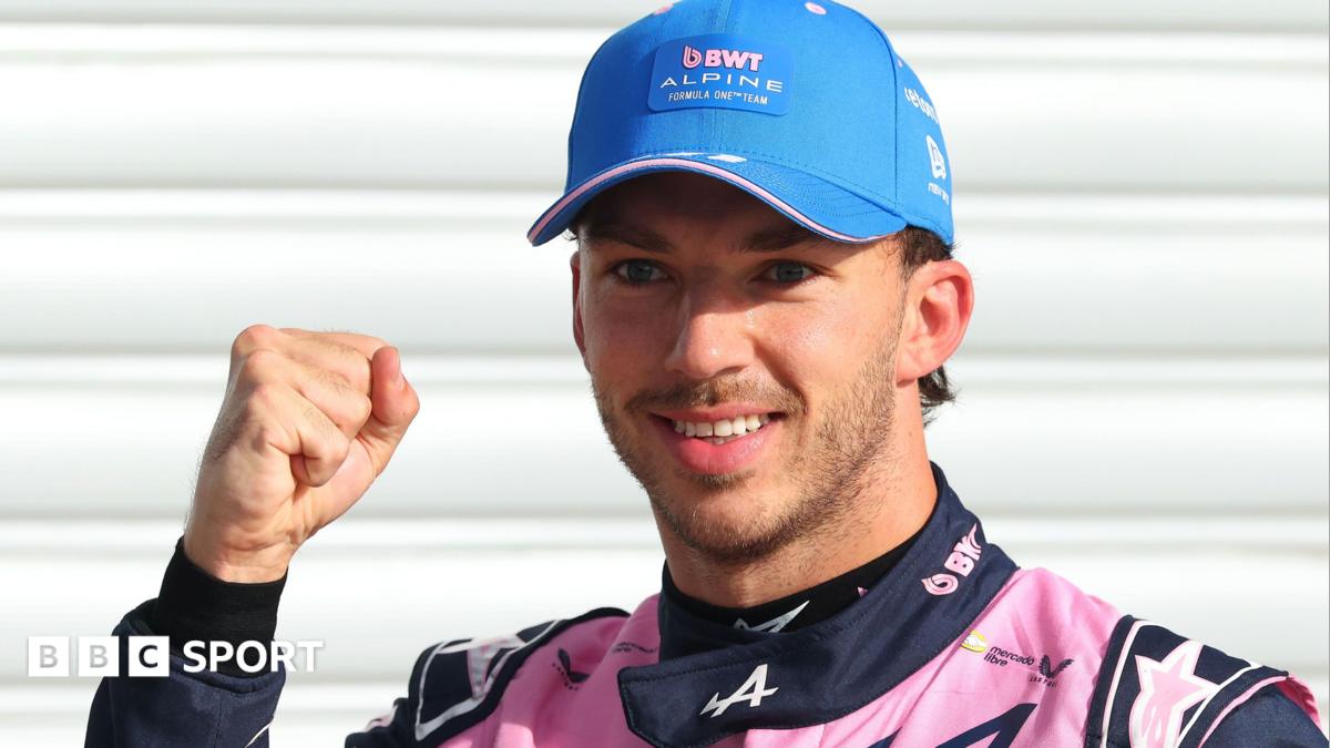 Alpine's Pierre Gasly poses with a picture of the '1' board after taking pole position at the Italian Grand Prix