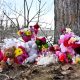 Flowers and toys lie on the ground near the site of a mass shooting at a high school, in the town of Tumbler Ridge, British Columbia, Canada February 11.