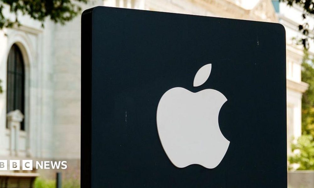 Apple logo illuminated on a black sign outside an Apple Store in Washington DC