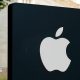 Apple logo illuminated on a black sign outside an Apple Store in Washington DC