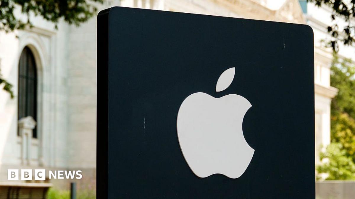 Apple logo illuminated on a black sign outside an Apple Store in Washington DC