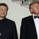 Xi Jinping and Donald Trump standing next to each other looking pensive, they are both wearing suits