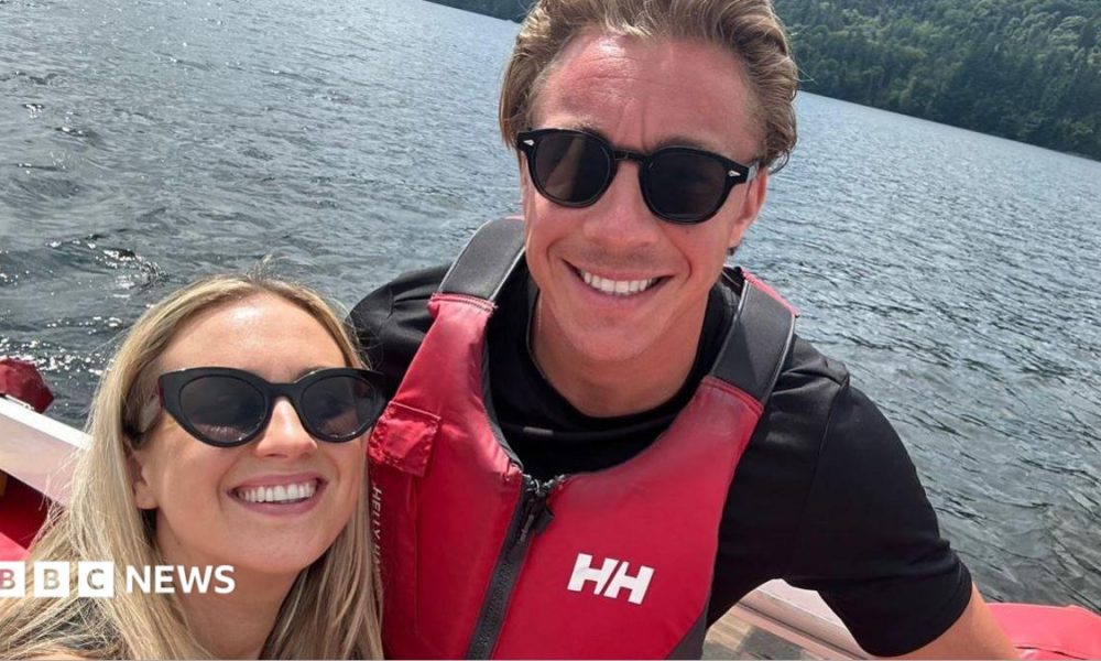 Molly and Taylor Haylett on a boat in the water smiling