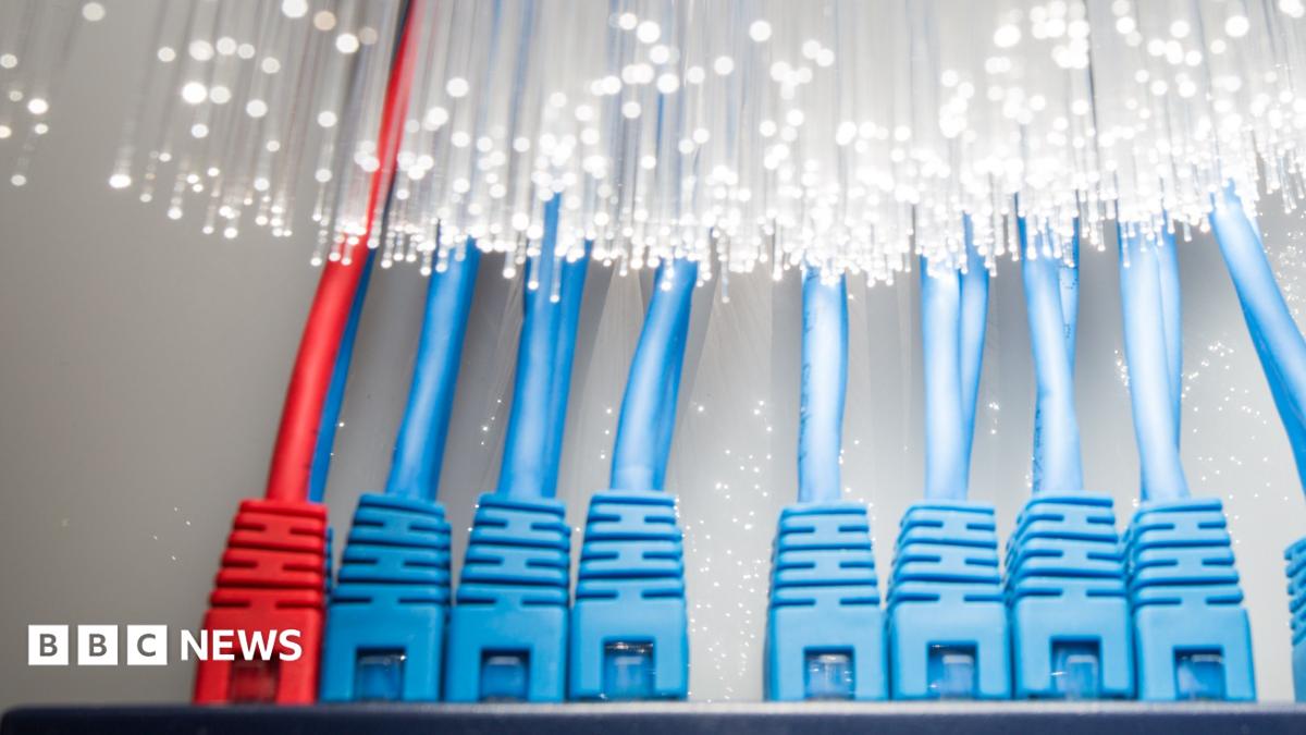 Two workers in hi-vis jackets work with bundles of cabling at a data centre project