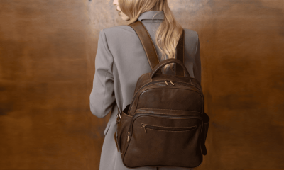 stylish professional woman wears mushroom colored suit and a dark brown backpack