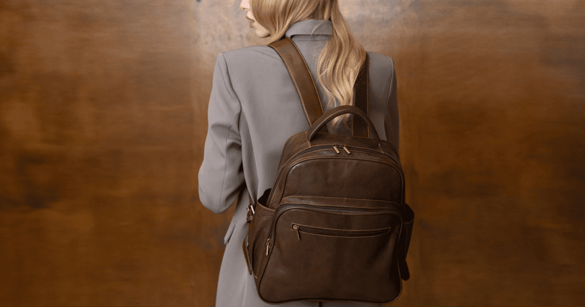 stylish professional woman wears mushroom colored suit and a dark brown backpack