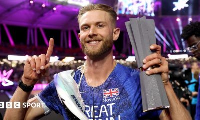 Josh Kerr celebrates with his Ultimate Championship trophy after winning the men's 1500m