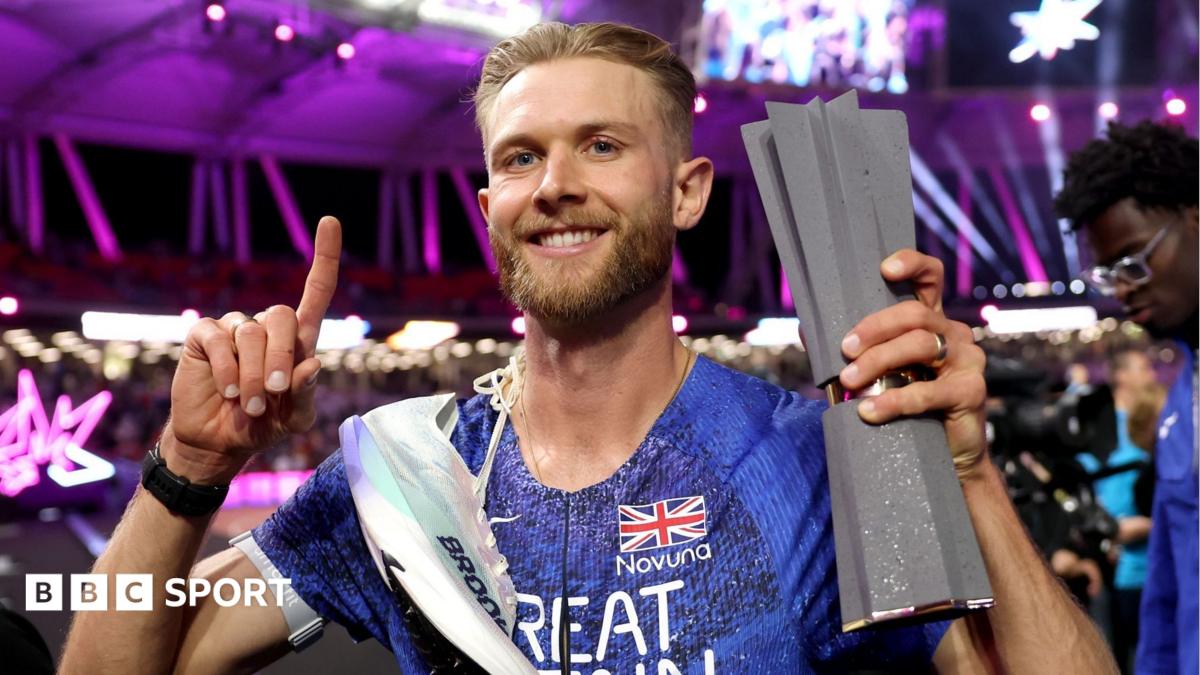 Josh Kerr celebrates with his Ultimate Championship trophy after winning the men's 1500m