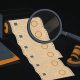 Illustration of a magnifying lens over a tape of near-identical trade tickets beside a resting gavel
