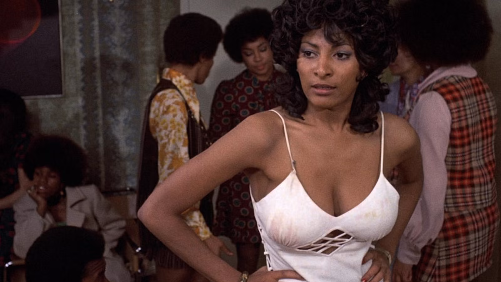 Coffy with her arms on her hips