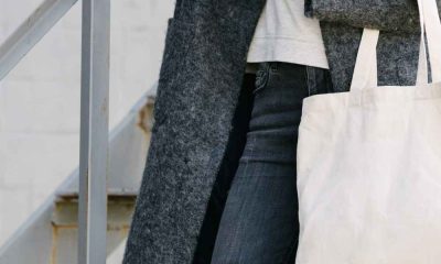 Close up of stylish woman carrying canvas tote bag
