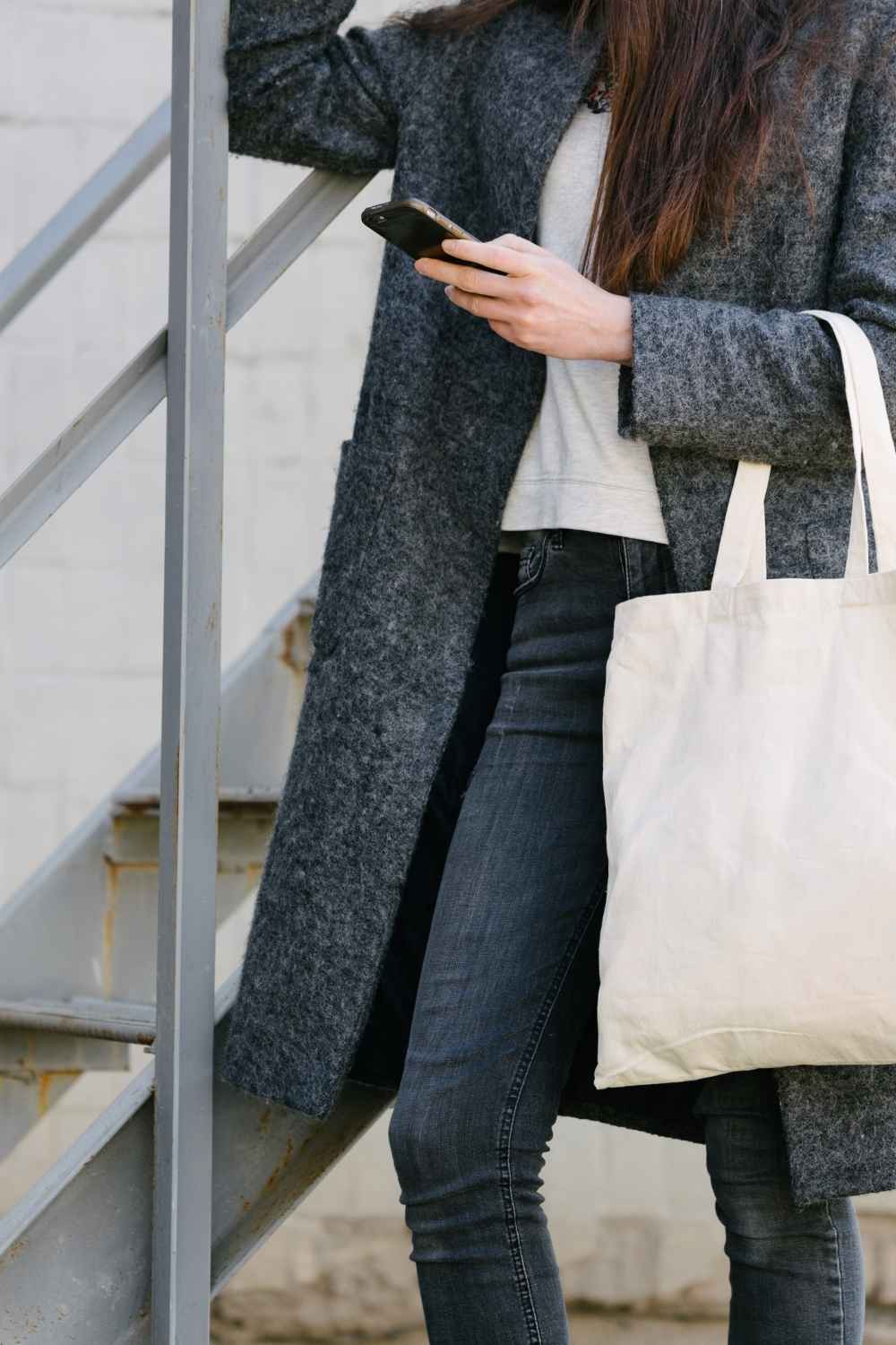 Close up of stylish woman carrying canvas tote bag