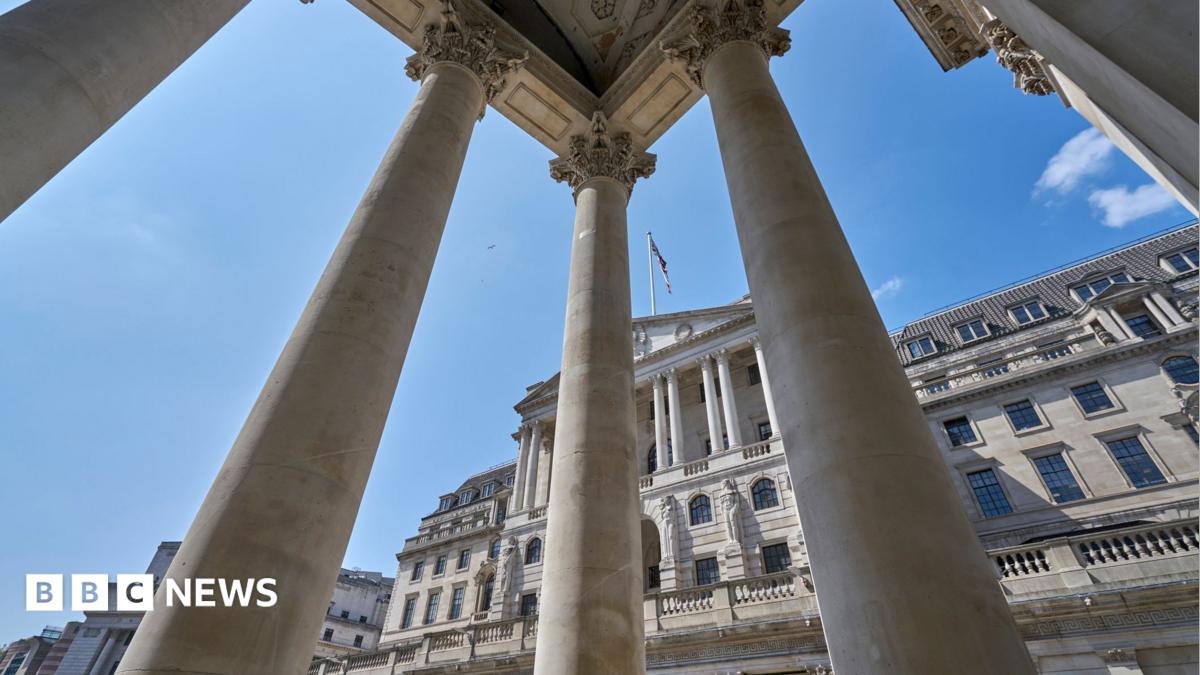 The exterior of the Bank of England with columns from a neighbouring building in the foreground.