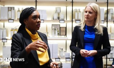Conservative leader Kemi Badenoch and shadow culture secretary Rebecca Paul visit a shop in Bicester Village. Behind them are shelves with toiletries and candles.