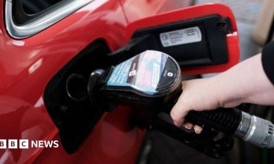 A woman fills a car with diesel from the pump