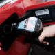 A woman fills a car with diesel from the pump