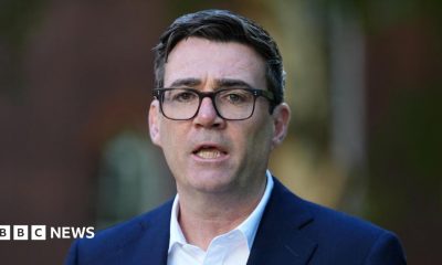 Andy Burnham wearing a navy suit and a white shirt.