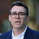 Andy Burnham wearing a navy suit and a white shirt.