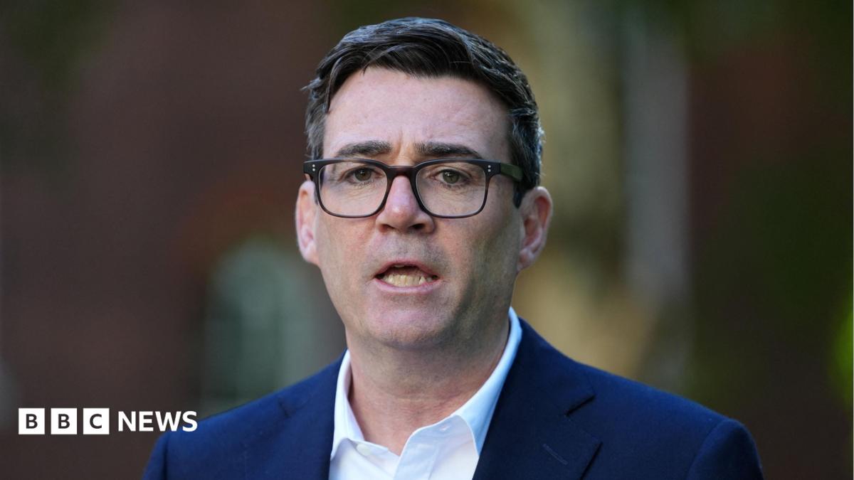 Andy Burnham wearing a navy suit and a white shirt.