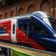 A new train stationed at Marylebone station in London. It is red, blue and white.