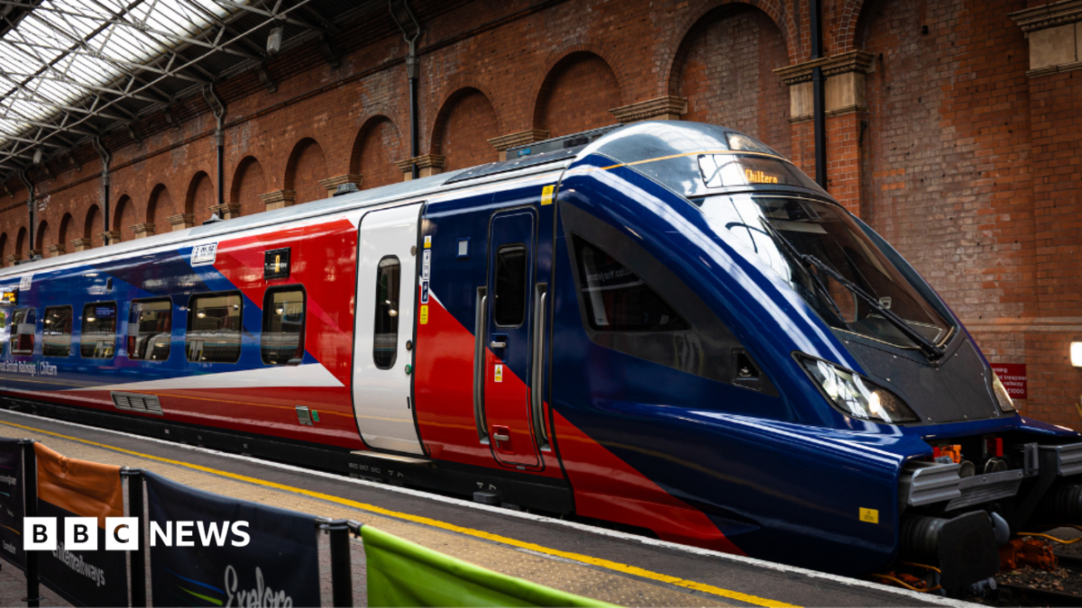 A new train stationed at Marylebone station in London. It is red, blue and white.