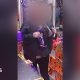 Shop customer with their face blurred putting a large chocolate bar under her jacket inside a shop