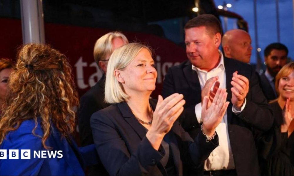 Sweden's Social Democratic Party leader, Magdalena Andersson applauds as she waits with other party members for general election results