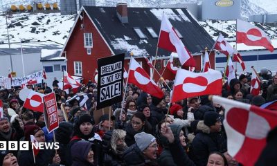 People bear Greenlandic flags as they gather in front of the US consulate in Nuuk, Greenland, in a protest against President Donald Trump's announced intent to acquire Greenland in January 2026