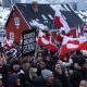 People bear Greenlandic flags as they gather in front of the US consulate in Nuuk, Greenland, in a protest against President Donald Trump's announced intent to acquire Greenland in January 2026