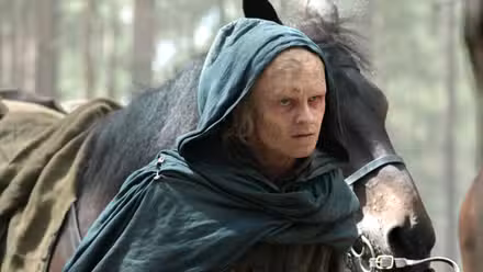 Tom Glynn Carney cloaked walking with a horse in 'House of the Dragon' Season 3