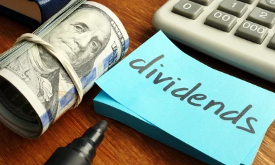 Dividends concept. Stack of dollars and calculator.