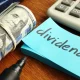 Dividends concept. Stack of dollars and calculator.
