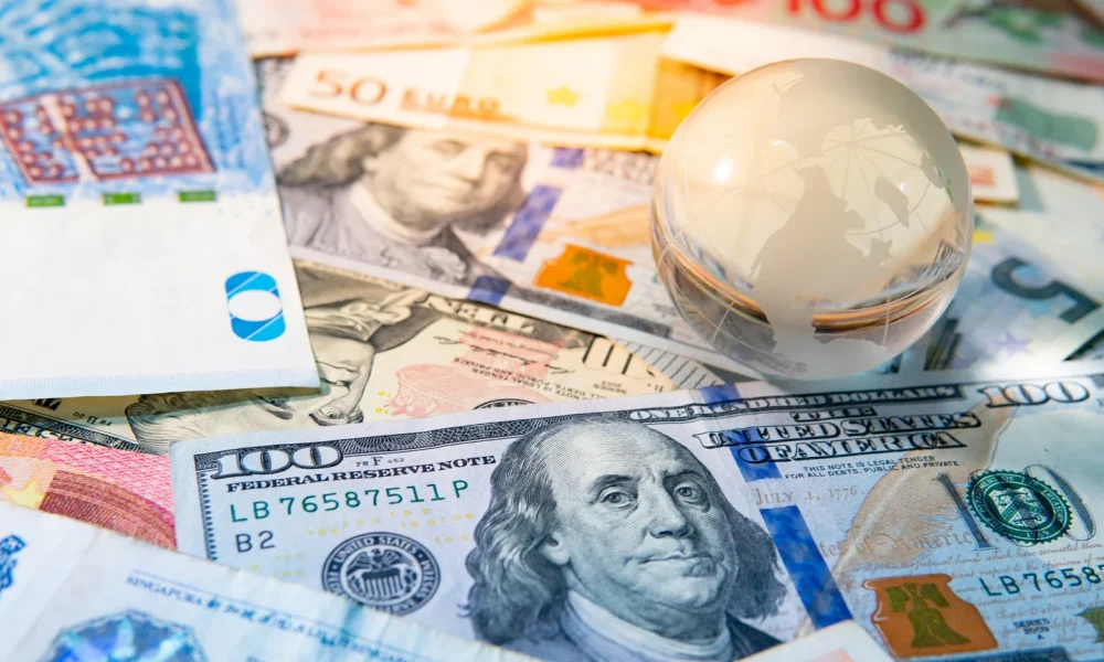 World globe crystal on various banknotes
