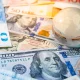 World globe crystal on various banknotes