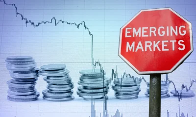 Emerging markets sign against economy background with graph and coins