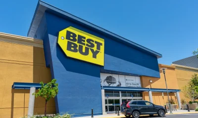 Best Buy store entrance, facade and exterior with customer car parked in front