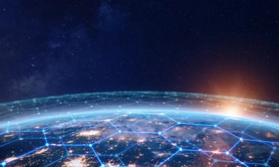 Communication network above Earth for global business and finance digital exchange. Internet of things (IoT), blockchain, smart connected cities, futuristic technology concept. Satellite view.